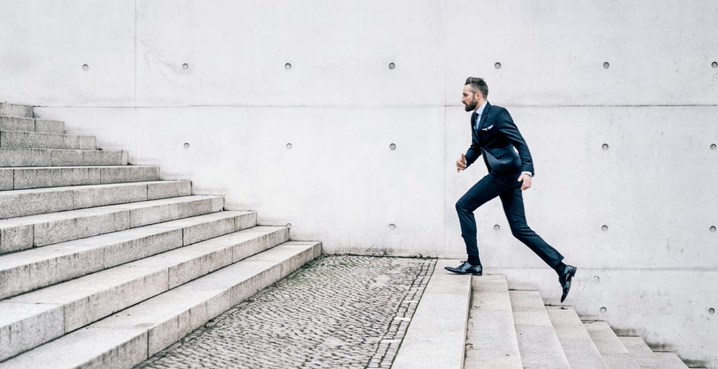 businessman running up stairs