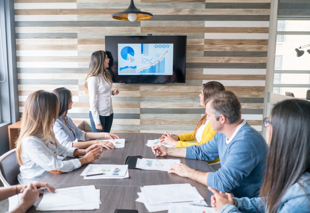 Business woman presenting analytic data charts in a meeting