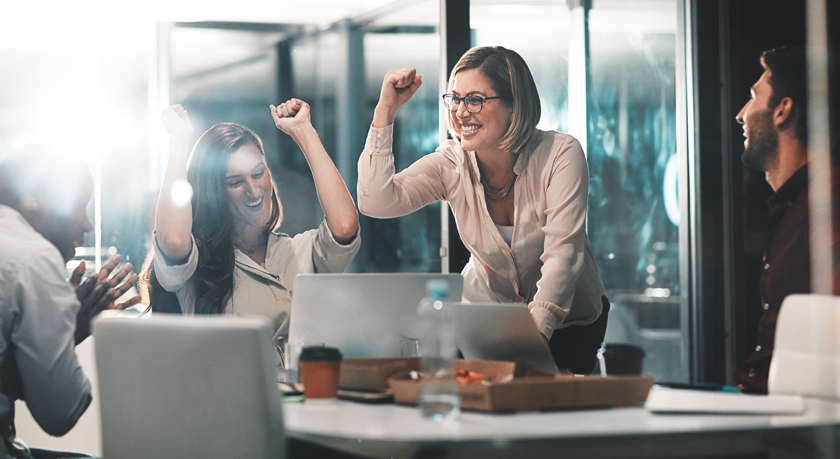 Coworkers celebrating in a meeting