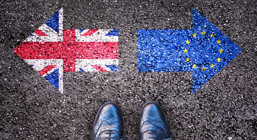 Brexit, flags of the United Kingdom and the European Union on asphalt road with legs