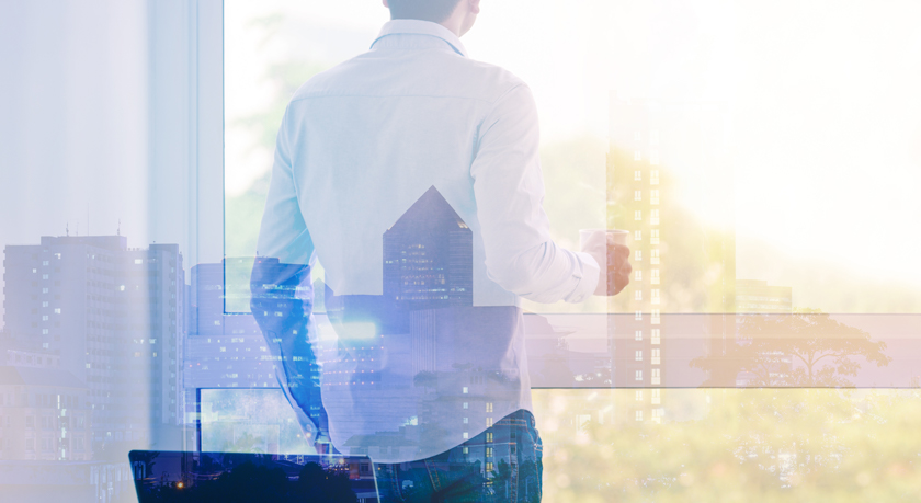 Businessman looking out window on cityscape