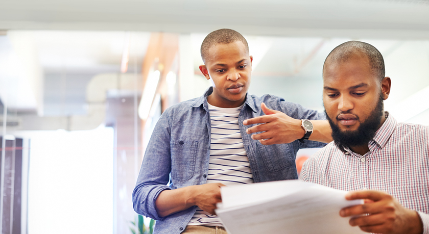 Two men reviewing relocation forms