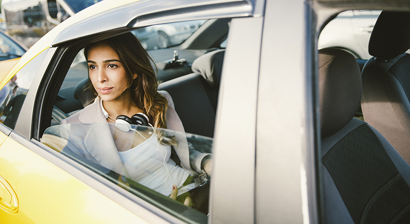 Woman in taxi looking for corporate housing