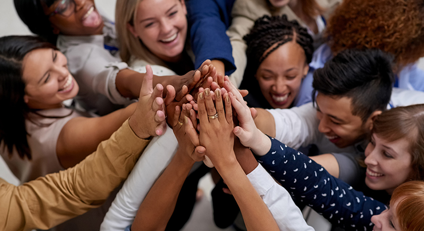 Group of people with their hands in