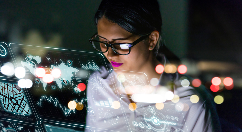 woman looking at various charts and information on a futuristic interface